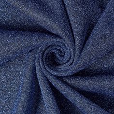 a blue fabric with small speckles in the center and a circular design on it