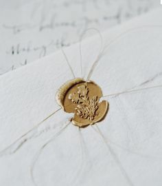 a close up of a piece of paper with a gold seal on it