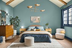 a bedroom with blue walls and wooden furniture in the corner, along with a white rug on the floor