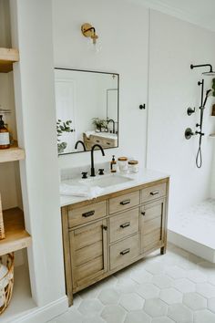 a bathroom with two sinks and open shelving