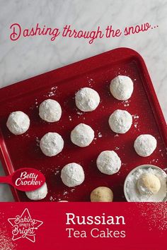 russian tea cakes on a red tray with the words dash through the snow above it