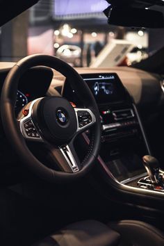 the interior of a bmw car is shown in this image, it's dashboard and steering wheel