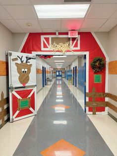 an empty school hallway decorated for christmas with decorations on the doors and in the center