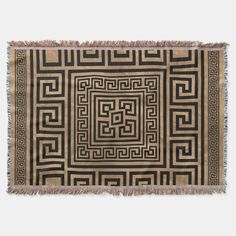 a black and beige rug with an intricate design