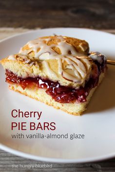 a slice of cherry pie bars with vanilla - almond glaze on a white plate