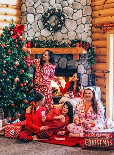 a group of women sitting around a christmas tree