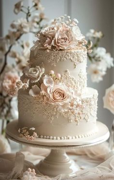 a white wedding cake with flowers on top