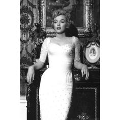 a black and white photo of a woman in a dress