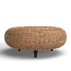 an oval woven foot stool with black legs and wooden feet, on a white background