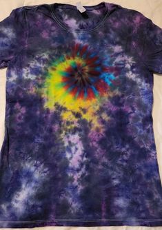 This is a Ladies Large Tie Dye short sleeve shirt in a blend of red, yellow, blue, purple with a spiral design - 'Radiant Lilac' Brand: Ladies' Fruit of the Loom Iconic T-Shirt - 4.6 oz., 100% ringspun cotton preshrunk jersey Size: L Size chart is approximate Care: Colors may run. Machine or hand wash cold separately. Hang dry. Hand dyed by me in my smoke free, pet free upstate NY home surrounded by nature at the foothills of the Adirondack Mountains. Shop our other items at https://crafxzen.etsy.com Find us on Facebook, Instagram and Twitter @crafxzen Website: https://crafxzen.com Multicolor Rainbow Print T-shirt With Short Sleeves, Festival Short Sleeve Multicolor Print Tops, Vibrant Multicolor Short Sleeve Shirt, Festival Multicolor Print Short Sleeve Tops, Fitted Rainbow Short Sleeve Tops, Multicolor Rainbow Print Tops For Festivals, Multicolor Short Sleeve Shirt For Festival, Festival Multicolor Tops With Rainbow Print, Festival Multicolor Rainbow Print Tops