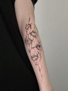 a person with a black and white tattoo on their arm that has many different things in it