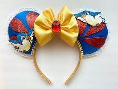 a close up of a mouse ears with a bow