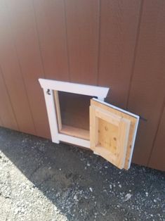 a dog house built into the side of a building