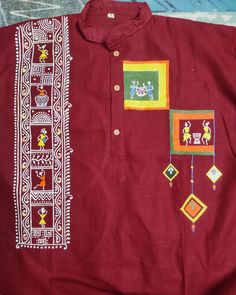 a red shirt with embroidered designs on it