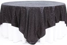 a black and white table cloth on top of a round table