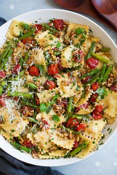 a white bowl filled with pasta and vegetables