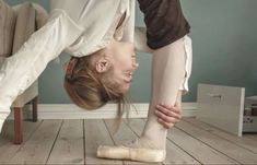 a woman doing a handstand on the floor