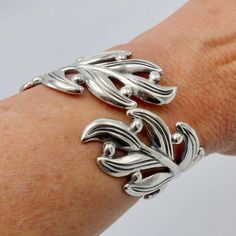 This is part of Chairish’s Costume Jewelry assortment.  A beautiful sterling silver hinged clamper bracelet by Margot De Taxco, made in Mexico, in a modernistic, stylized leaf design with flat and curved surfaces. This Margot de Taxco design is known as "Silver Leaves", or sometimes "Leaf and Berries". The bracelet is signed on the interior by the maker and also the pattern number 474. The bracelet is solid and weighs 67.4 grammes and is in excellent condition including a tight spring.It measure Taxco Silver Jewelry, Stylized Leaf, Silver Leaf Bracelet, Mexican Silver Jewelry, Silver Leaves, Mexican Jewelry, Leaf Bracelet, Upcycled Jewelry, Vintage Mexican