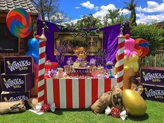 a table with candy and balloons on it in front of a sign that says poppinnickt