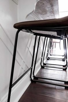 a row of chairs sitting next to each other on top of a hard wood floor