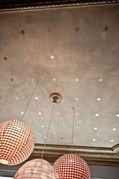 three lamps hanging from the ceiling with stars on them