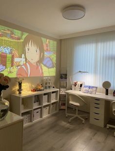 a child's room with a large screen on the wall and desks in front of it