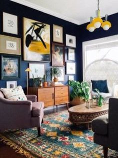 a living room filled with furniture and pictures on the wall