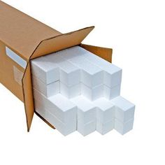 an open cardboard box with several white boxes in it