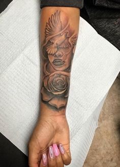 a woman's hand with a tattoo on it and a rose in the middle