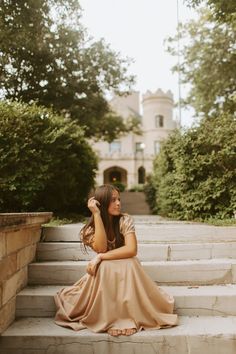 a woman is sitting on some steps outside