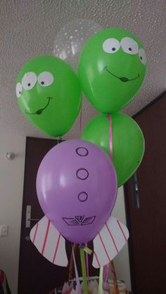 some balloons that have faces on them