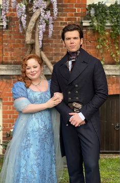 a man and woman dressed in period costumes