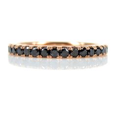 a black diamond band in yellow gold