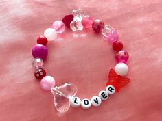 "❦ express your love wherever you go with these adorable \"lover\" valentine's day themed bracelets! ❦ size: 17-18cm / 7-8inches. the string is a stretchy material made to comfortably fit a wide variety of wrist sizes! ❦ created using a wide variety of round red, white, and pink colored beads. includes the words \"lover\" using round letter beads ❦ DISCLAIMER: all bracelets will be slightly unique to one another since i incorporate different beads in each one. the bracelet you receive may not be Lover Bracelet, Valentines Galentines, Themed Bracelets, Jewelry Friendship, Lovers Bracelet, Galentines Day, Valentine Ideas, Pink Valentines, Letter Beads