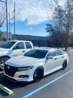 two white honda accords parked in a parking lot next to each other on a sunny day