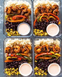 four trays filled with rice, beans and shrimp next to dipping sauce on the side