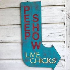 a wooden sign that says pies show live chicks on the side of a building