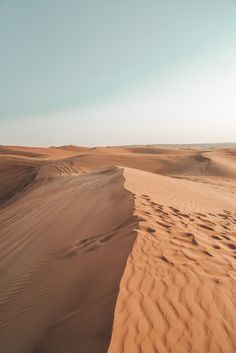 the sand dunes in the desert are brown