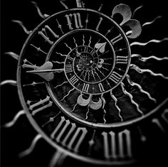 a black and white photo of a clock face