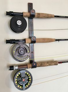 there are many different types of fishing rods on the wall, including one with a fly rod