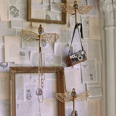 a wall covered in pictures and hanging on hooks