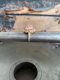 Beautiful vintage 14kt gold ring set with a cluster of rubies and sapphires. The top has a tiered flower design with the rubies at the top center and the sapphires circling the rubies. The inside of the shank is stamped 14kt. The cluster top measures 17mm diameter. There are twelve(12) round sapphires and seven (7) round rubies. Circa 1970s. Size: 4.75 Weight: 5.9 grams This can be sized for additional charge. Please message me before purchase. Heirloom Red Gemstone Cluster Ring, Vintage Ruby Multi-stone Cluster Ring, Vintage Multi-stone Ruby Ring For Gift, Antique Multi-stone Gold Ruby Ring, Sapphire Ring Vintage, Vintage Multi-stone Ruby Ring In 14k Gold, Ruby And Sapphire, Ring Ruby, Round Sapphire