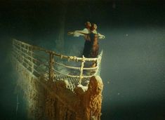 two people standing on the edge of a rope bridge