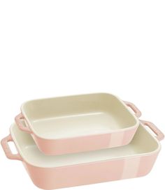 two pink casserole dishes sitting on top of each other