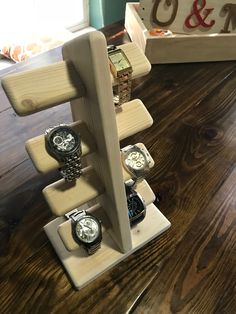 there are many watches on the wooden stand