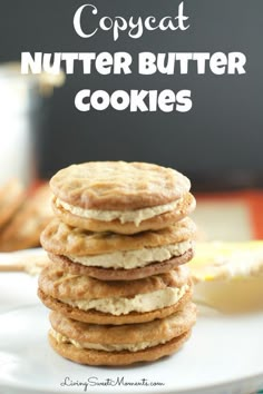 a stack of cookies sitting on top of a white plate with the words copycat nutter butter cookies