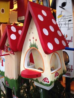 a bird house with red roof and white polka dots on it