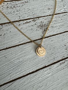 The sweetest necklace ever….featuring a hand stamped heart set on a larger stamped disc and a dainty chain, this little beauty goes with everything! Material is 14k gold filled. Chain measures 16” Handmade at the time you order. Dainty Hand Stamped 14k Gold Charm Necklaces, Dainty Hand Stamped 14k Gold Necklace, Dainty Hand Stamped Charm Necklaces For Everyday, Dainty Hand Stamped Charm Necklace For Everyday, Dainty Hand Stamped Charm Necklace For Anniversary, Dainty 14k Gold Filled Engraved Charm Necklaces, Dainty Hand Stamped Necklaces For Anniversary, Dainty Hand-stamped Charm Necklace For Anniversary, Dainty Hand Stamped Jewelry As Gift For Mom