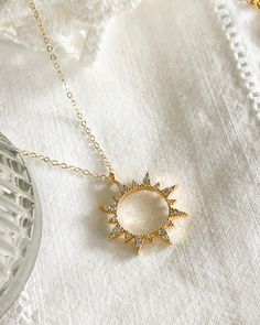 First the moon, then the sun. Add the Sun Necklace to your collection today. Cubic zirconia sun Charm size: 19.5x22.5mm 14kt Gold plated brass pendant & gold filled chain All items come in a gift box ready to gift. To see more please visit my Etsy shop at https://www.etsy.com/shop/BijouLimon Bijou Limon jewelry collections present a romantic French spin on the latest jewelry trends. Based on the US West Coast but French at heart, Bijou Limon interprets the current jewelry trends and delivers tim Sun And Moon Design Necklace For Gift, Sun And Moon Design Necklace As Gift, Elegant Sun Design Pendant Necklace, Gift Moon And Sun Design Necklaces, Celestial Sun And Moon Necklace, Round Adjustable Necklace With Sun And Moon Design, Adjustable Round Sun And Moon Design Necklace, Celestial Cubic Zirconia Pendant Necklace, Cubic Zirconia Moon Charm Necklace With Round Pendant