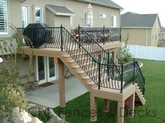 a house with a deck and stairs in the front yard